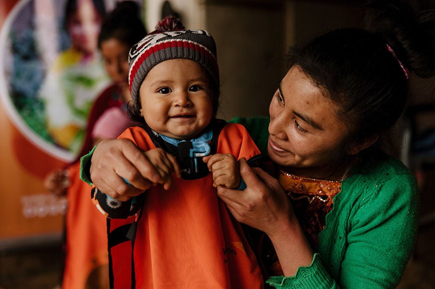 Reina holds her 18-month-old daughter, Amanda, as they attend World Vision’s Go Baby Go program in Concepción Chiquirichapa, Guatemala. The program provides support for mothers and caregivers from pregnancy through to the baby’s first three years of life—helping to strengthen families and provide the best start to life for kids. (Photo credit: Ben Adams)