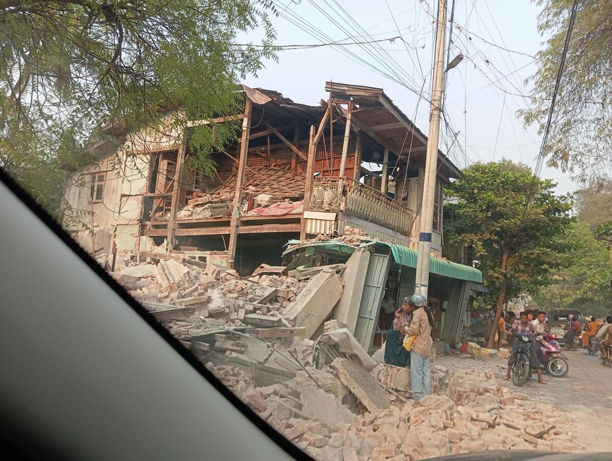 Rubble surrounding a partially destroyed building in Myanmar