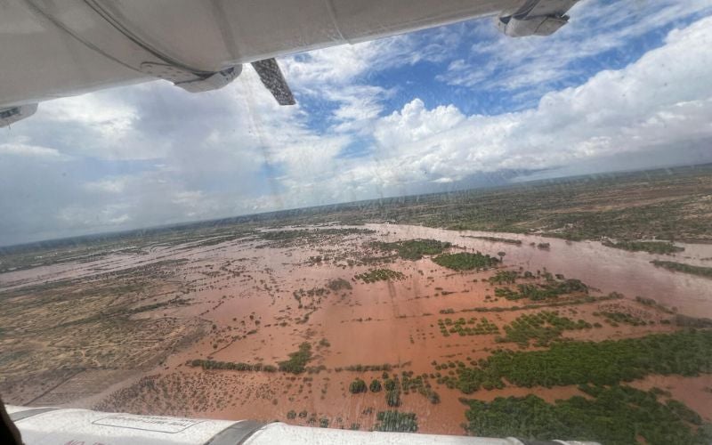 The view from a plane flying over a flooded region. The scene is mostly water.