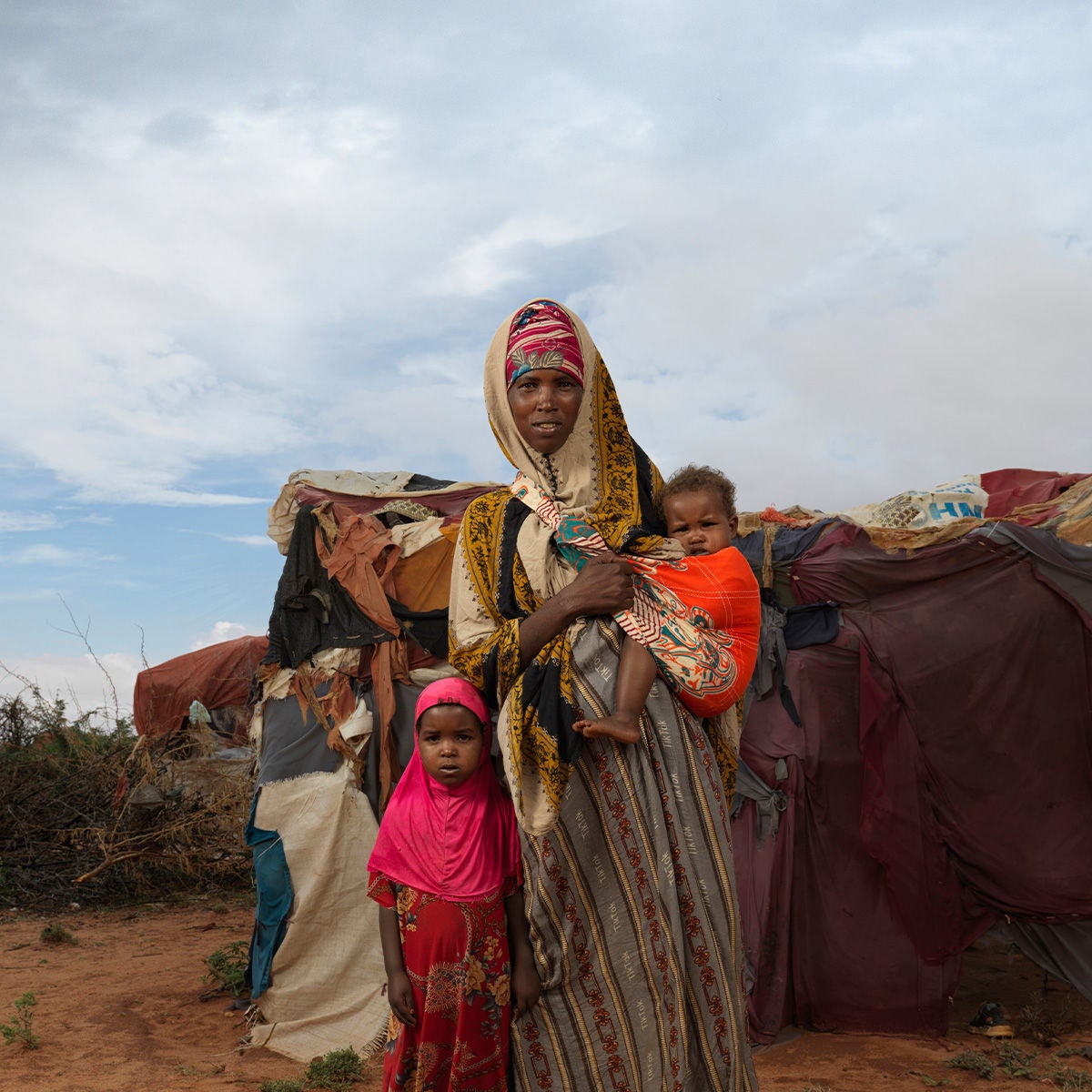 A woman with her two children near a make-shift tent in a drought-affected area in Somalia.