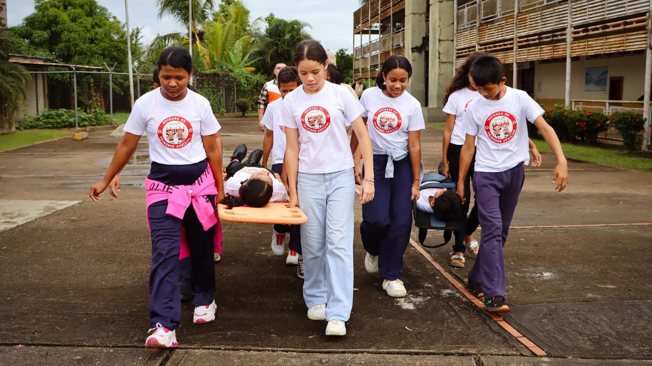 Students practice first aid and disaster response during a school drill in Venezuela.