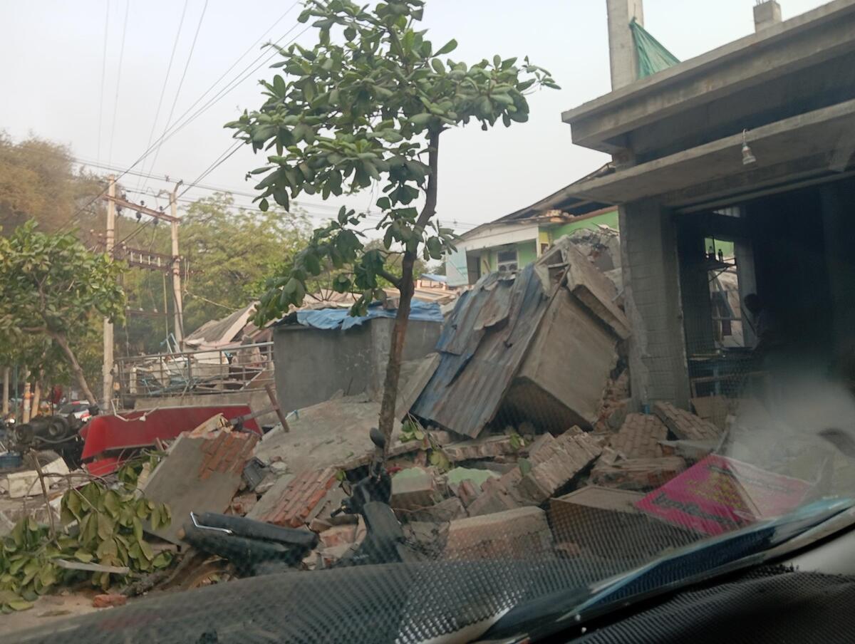 Rubble surrounding a partially destroyed building in Myanmar