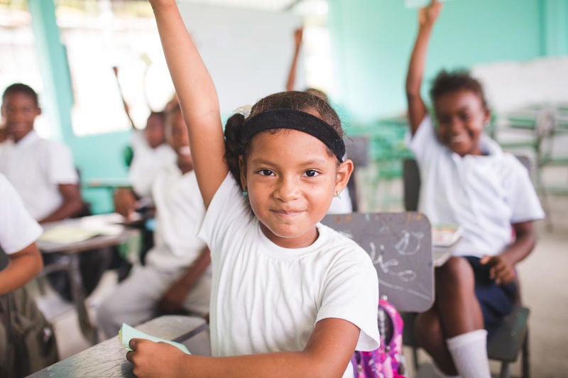 Children answer questions in their classroom in Ecuador