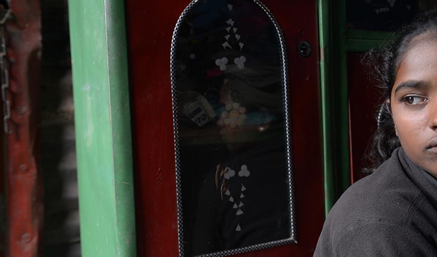 Young woman looks into distance with a serious expression.