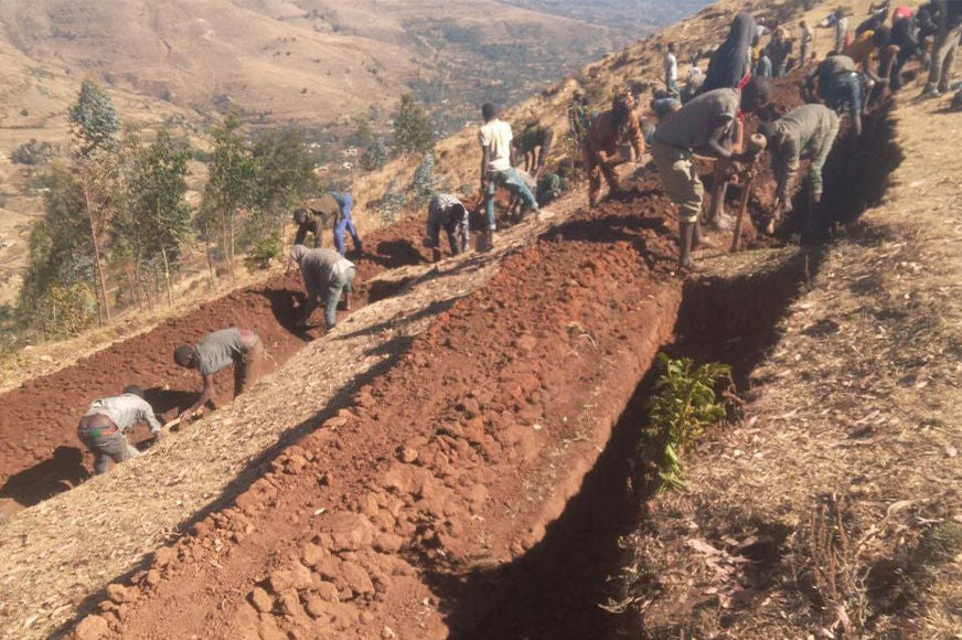 Community members participate in a soil and water conservation activity.