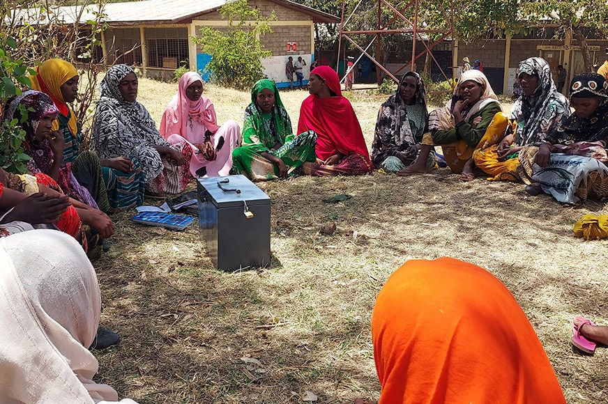 Female savings group members participate in a regular weekly meeting.