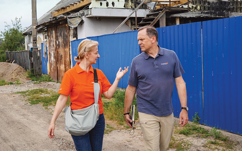 Michael Messenger, World Vision Canada CEO, walks in the field with a World Vision staff.