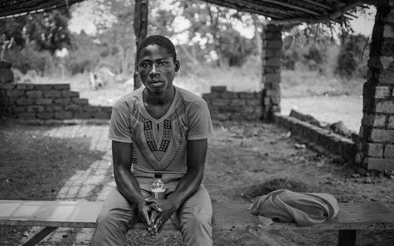 Damara, Central African Republic. 

Clara Degoto, 18 (baby: Ketura Yaouba, 1) – When Seleka attacked Damara, she fled into the bush with her mother. Her father died. When she came out of the bush to find food, the Seleka forced her to join the group. Initially she wasn’t too upset about it because she saw that they were eating chickens and goats and thought she would be able to get food. For nine months she cleaned their weapons and did whatever the leaders told her. She worried about her mother, who didn’t know where she was. She never killed anyone but the boys who joined did. The reason she escaped was because she couldn’t deal with the horrors she was seeing each day. She escaped and around the same time Damara was stabilized and became secure. She still lives in fear that they will come back. Since then she has had a baby girl and joined the WV Peace Club. At the Peace Club she met Lionel Jeun (17), who was also a child soldier, but for the opposition – anti-Balaka. They said it took about a year for them to accept each other and realize that they weren’t really opponents, because they both wanted the same thing – peace.

In 2013 rebel armed groups attacked Damara (a sub-prefecture 75 kilometres from the capital, Bangui) and recruited children to serve in their ‘forces’. In 2014, World Vision assisted nearly 8,000 children in Damara, a sub-prefecture, -where it carries out child protection activities.

Through the support of World Vision and the community members led by their leaders, the children were rescued, rehabilitated and enrolled in peace clubs. Some returned to school while those who were beyond schooling years, were enrolled in vocational training.

World Vision’s primary goal in doing this was to empower the children and young people to become agents of peace and promote peace-building initiatives in their own communities. A total of 4,944 children comprising 2,604 boys and 2,340 girls were trained on the culture of peace and social cohesion. 302 of these children comprising of 204 boys and 98 girls rescued from the armed forces and armed groups (ESFGA).

Besides the children, their parents and members of the community including their community leaders were trained on ways to ensure children are protected from harm. These included, referrals of abuses committed against children such as rape. In total, 30 men and 15 women participated in the training.  