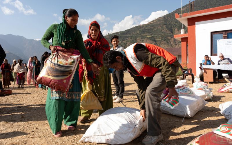 Two women receiving bags of aid