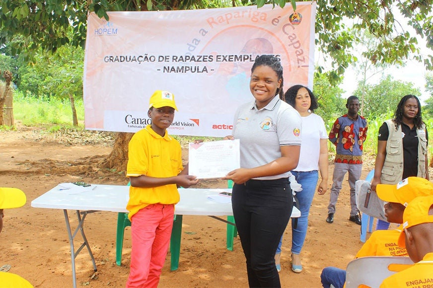 A young man receives a graduation certificate.