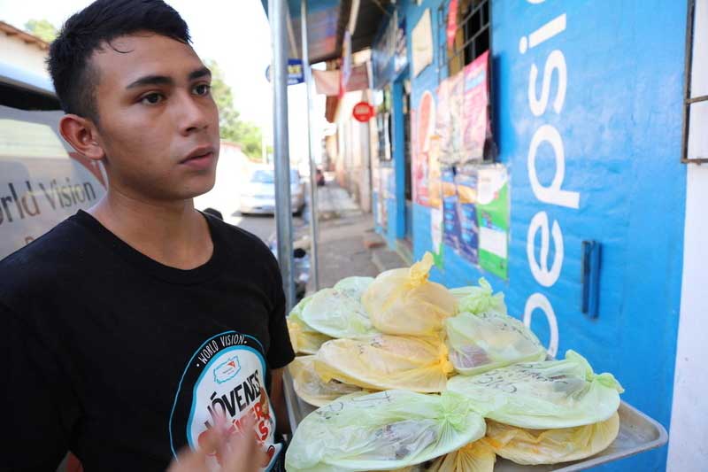 Northern Triangle - Young man selling food