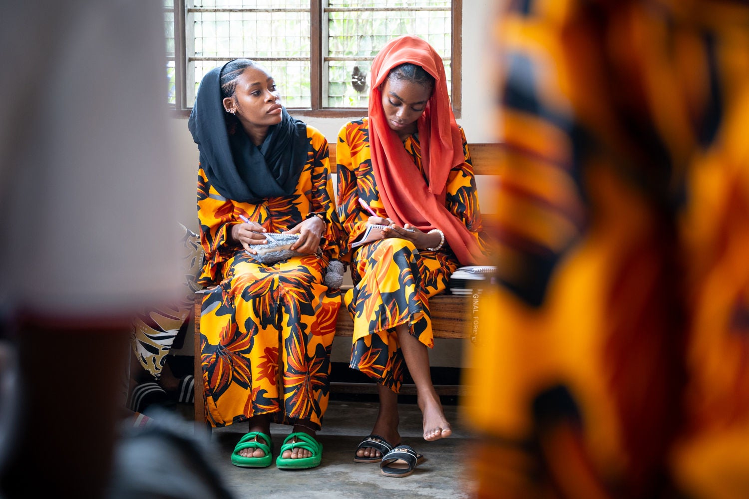 Adolescents participate in the AHADI project's peer group sessions. AHADI is advancing gender equality by contributing to the increased realization of the sexual and reproductive health and rights, well-being and dignity of marginalized girls (aged 10-24 years) in urban municipalities of Tanzania. AHADI provides a safe space for adolescent and youth girls and boys to unpack harmful, restrictive constructs of masculinity and femininity. (Photo credit: Paul Bettings / World Vision Canada)
