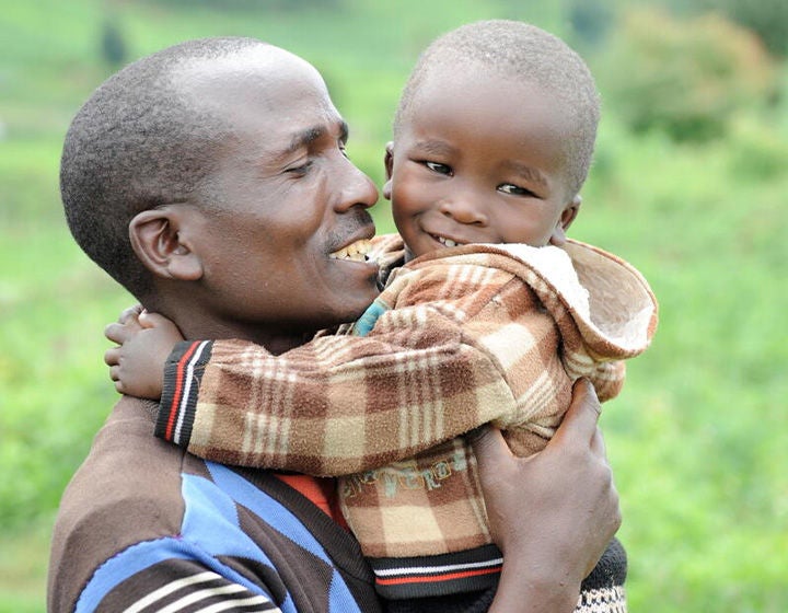 A father holding a child.