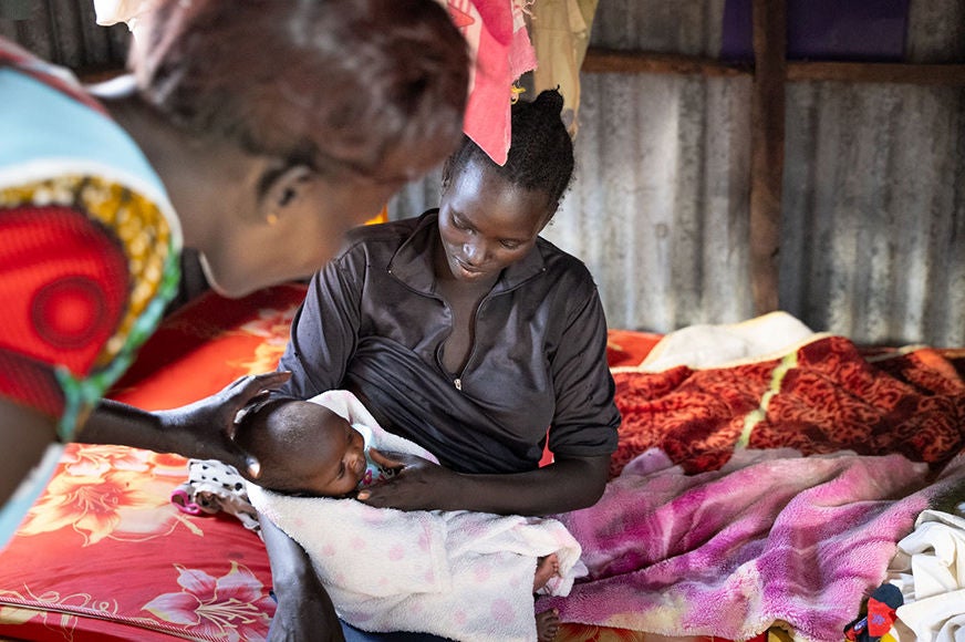 A woman holds a baby.