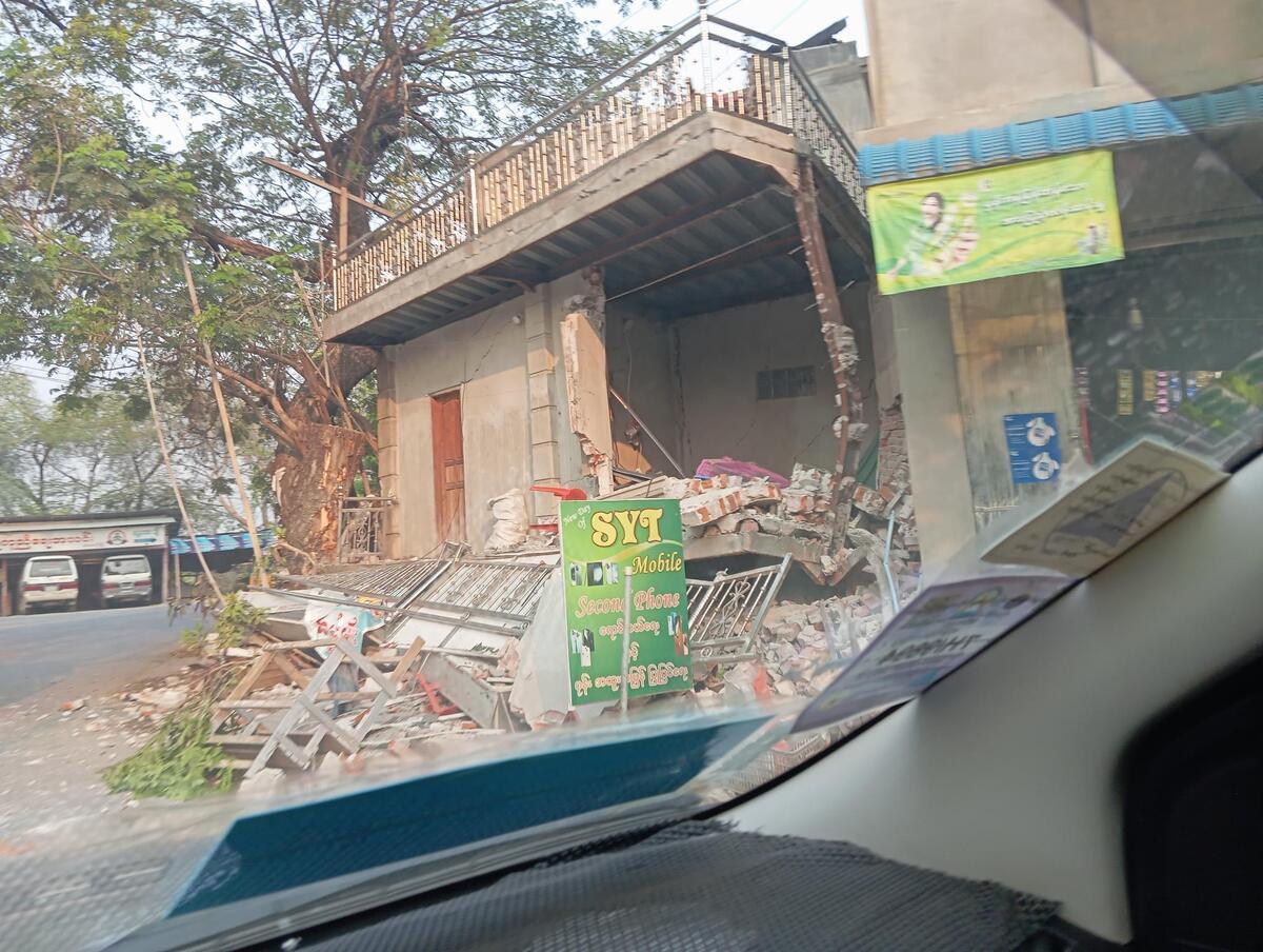 Rubble surrounding a partially destroyed building in Myanmar