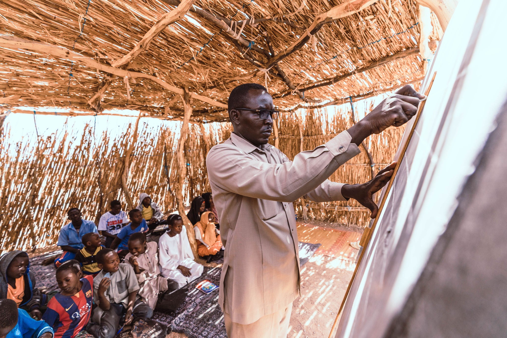 A teacher instructs children at a school for Sudanese refugees in Chad. (Amy Van Drunen / World Vision)