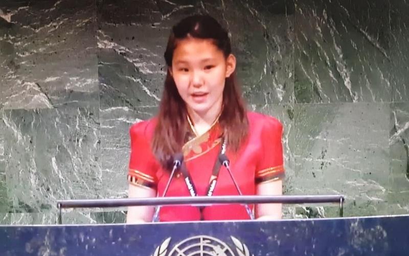 Nomundari stands at a podium at the United Nations.