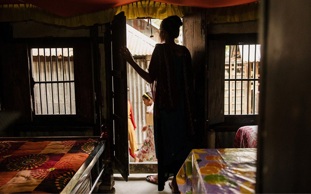 Farah, a child marriage survivor, is looking outside her home in Bangladesh.