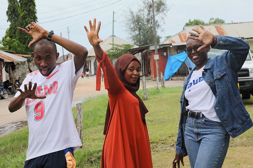 Three adolescents pose for the camera.