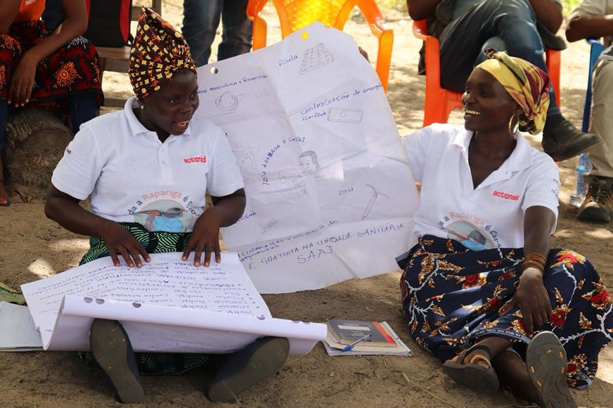 Two women present using chart paper.