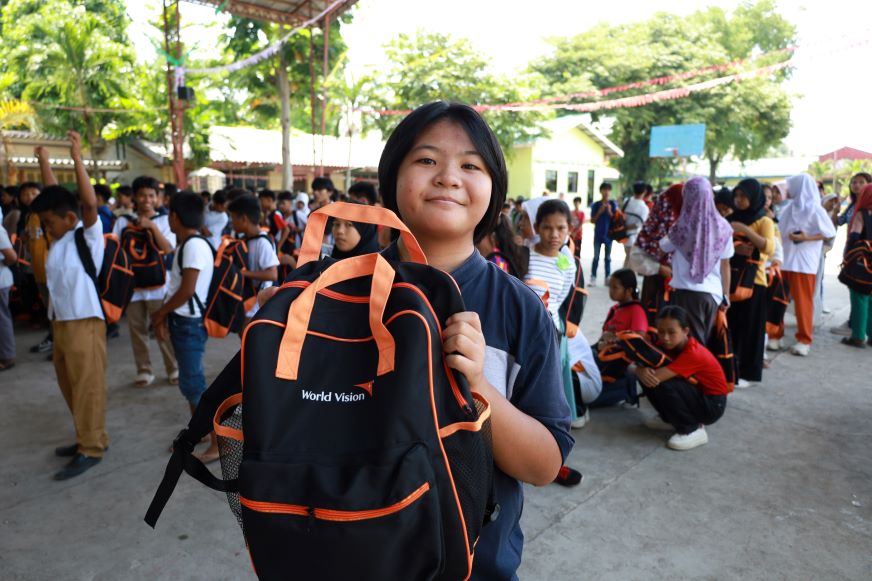 Pamela, 12, shows off her new bag. “It's like a blessing for me, because there are no kids who receive this like us,” she says.