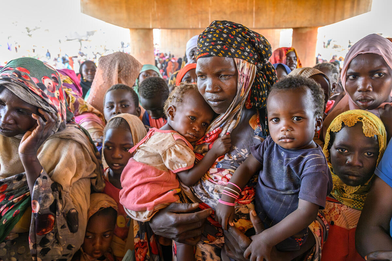 Here, some 2000 refugees from Sudan seek shade under a bridge that connects their country with Chad. They’re waiting to be processed.  