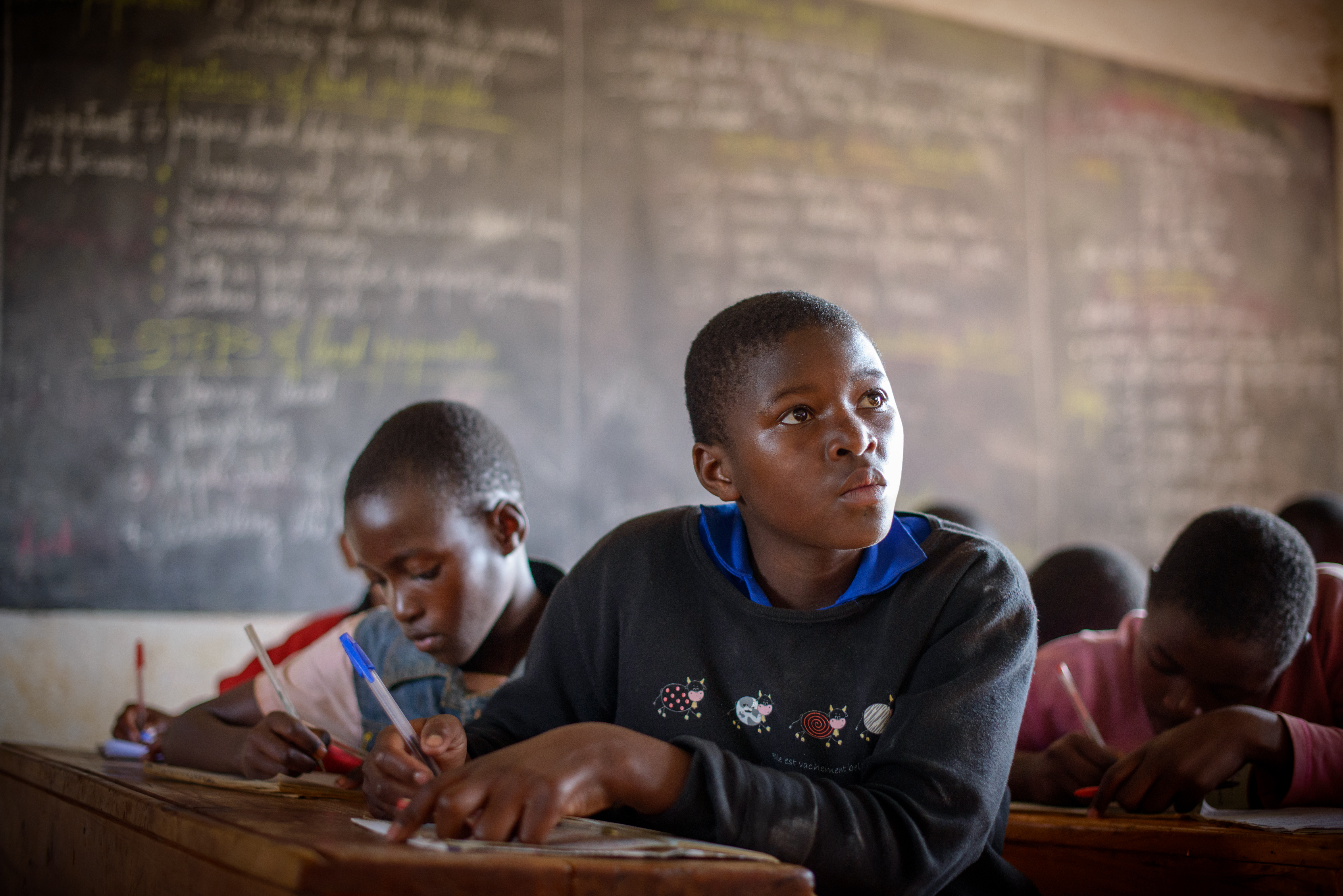An archival photo of Callixte’s daughter Jossiane in class, after World Vision and others helped resurrect the education system post-genocide. Photo: Jon Warren 