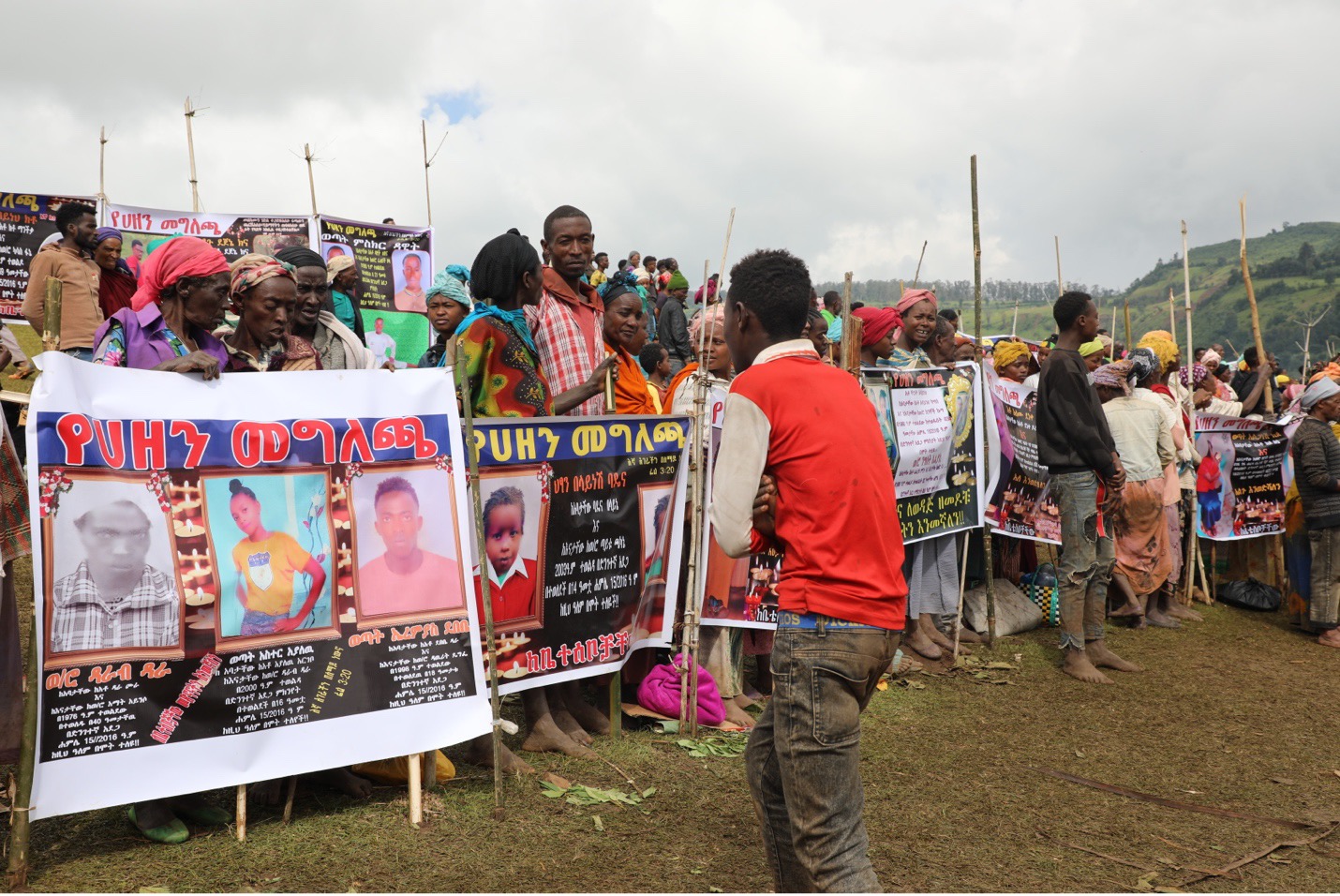 As aid agencies, government and media arrived, people showed posters of their deceased loved ones. 